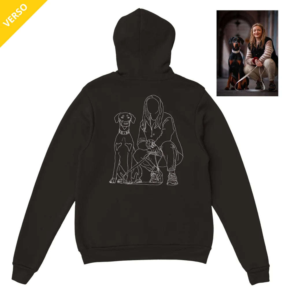 Sweat à capuche noir avec un dessin au trait d’une personne et d’un chien dans le dos.